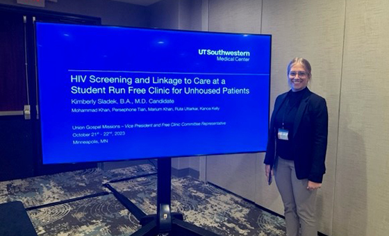 Smiling woman standing next to her digital SRFC research poster